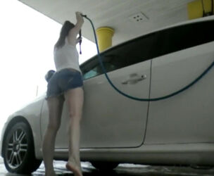 Slender woman car washer showcasing bra-stuffers and