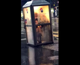 Brit duo tears up in telephone booth in center of city